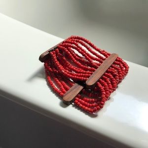 Wooden bracelet with orange beading